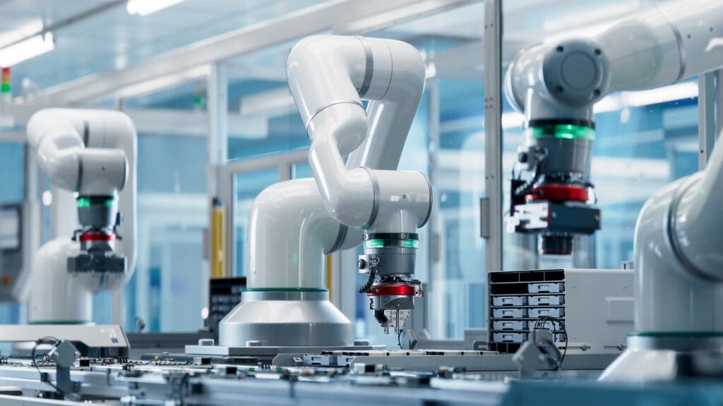 Advanced robotic arms in a cleanroom environment perform precise assembly tasks on electronic components, showcasing automation technology in manufacturing.